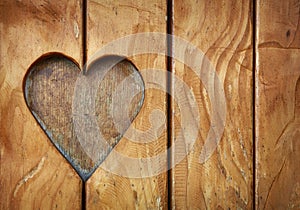 One heart shape carved in vintage wood close up