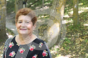 One Hispanic senior woman smiling outdoors