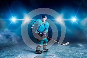 One hockey player skating on ice arena