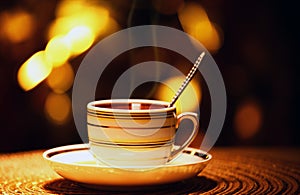 One hot tea cup spoon gold bokeh nobody