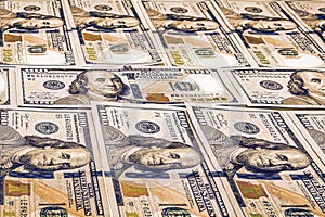 One hundred american dollars background. Many bills. A pile of US dollars banknotes. Money texture