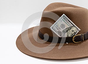 One hundred american dollars banknote close-up in brown felt hat