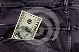 One hundred American Dollars Banknote in a jeans pocket on rotating table. Extreme close-up, Shallow Depth of Field