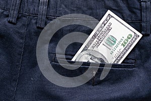 One hundred American Dollars Banknote in a jeans pocket on rotating table. Extreme close-up, Shallow Depth of Field