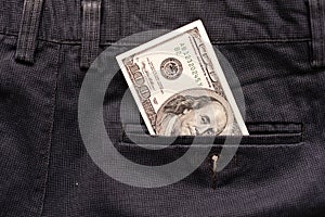 One hundred American Dollars Banknote in a jeans pocket on rotating table. Extreme close-up, Shallow Depth of Field