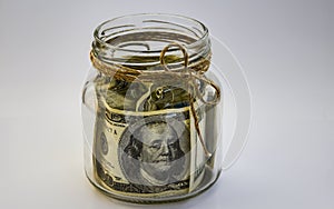 One hundred american dollars in the jar on the white backround with copy space, savings