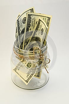 One hundred american dollars in the jar on the white backround with copy space, savings