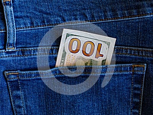 One hundred dollar banknote money in back pocket jeans pants background texture. 100 dollar bill close up