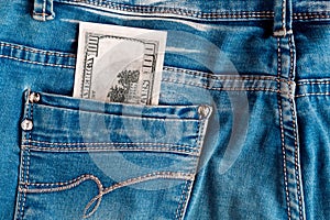 One hundred dollar bill in the jeans back pocket.