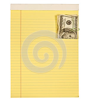 One hundred dollar bill paper clipped to yellow lined paper