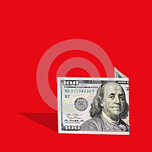 . one hundred dollar bill on a red background, a creative trend idea