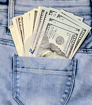 One hundred dollar bills in the pocket jeans