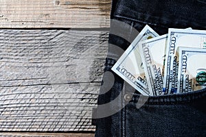 A one hundred dollar notes in the front pocket of denim trousers