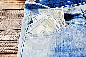 A one hundred dollar notes in the front pocket of denim trousers