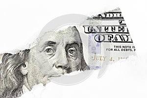 One hundred dollars bill fragment, Benjamin Franklin portrait on 100 banknote in torn paper hole. New sample money