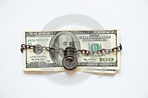 One hundred dollars on a chain under lock and key on a white background ,business