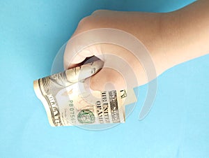 One hundred dollars in a child's hand. A bill in a child's hand