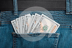 One hundred dollars or 100 dollar bill in the back pocket of jeans. Money United States of America. Bank financing.