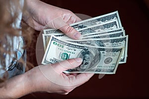 One hundred dollars inthe girl's hand