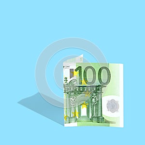 . one hundred euro banknote on a blue background, a creative trend idea