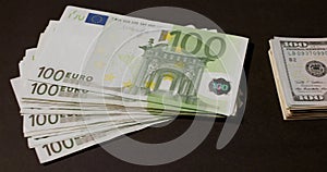 One hundred Euro banknotes on black background. Euro currency