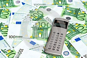 One hundred Euro banknotes and calculator, money background