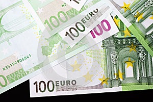 One Hundred euro banknotes on a dark background
