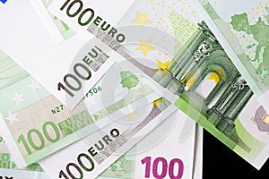 One Hundred euro banknotes on a dark background