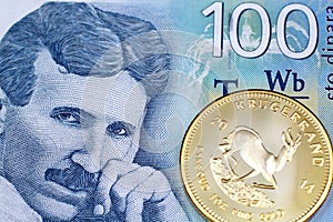 A one hundred Serbian dinar bank note with a gold krugerrand coin