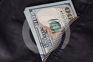 One hundred US dollar bills in jacket pocket