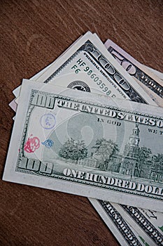 One hundred US dollars bill damaged by red ink stamp imprint