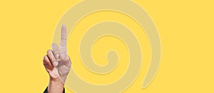 One index finger yellow background, person click button or touch pointing.