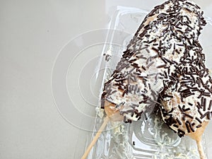 one of the Indonesian snacks, made from flour dough that is shaped into a round, then skewered and fried. then given a topping photo