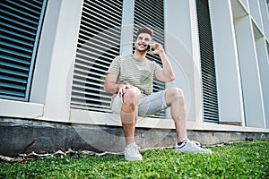 One isolated handsome man having a cell phone call with a friend. Happy male teenager talking using a smartphone. Young