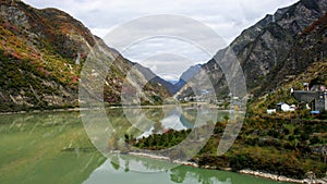 One of Jiuzhaigouâ€™s many lakes reflecting the colourful fall foliage and Min Mountains in Jiuzhaigou Valley National Park.