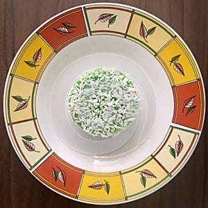 One Kuih Lopes on a round plate. square photo image.