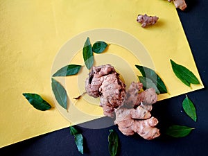 One Large piece of Ginger surrounded with curry leaves