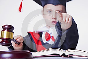 One law for all concept. Close up portrait of serious child girl judge lawyer makes a decision. Humorous photo. Selective focus