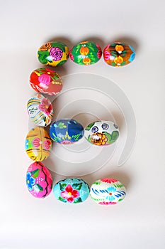 One of the letters of the word `Easter`. Letters are made of Easter eggs