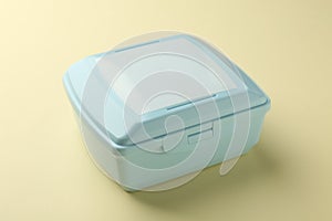 One light blue lunch box on beige background