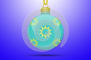 One light blue turquoise hanging christmas tree ball with golden stars ornaments on a blue background with lens flare