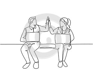 One line drawing of young happy couple business man and business woman opening their laptop and giving high five gestures.