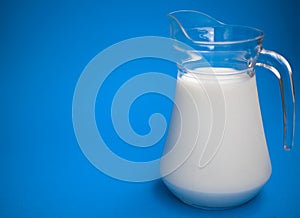 One liter of milk in a glass jug.