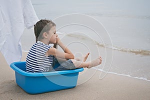 One little boy playing on the beach at the day time