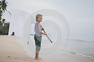 One little boy playing on the beach at the day time