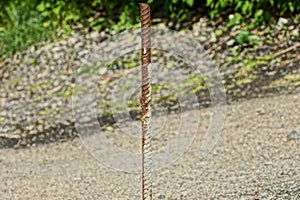 One long rusty iron rod brown rebar