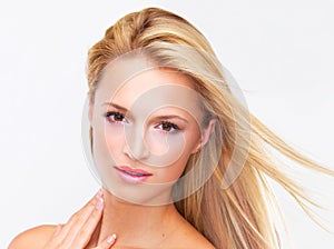 One look and shell have you mesmerised. Portrait of a beautiful blonde woman with flawless skin gazing at you, isolated
