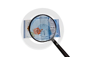 One Malaysia Ringgit bill and magnifying glass