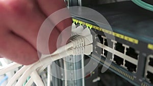 One male IT engineer working in a data center with rows of server racks and super computers.