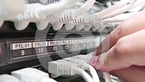 One male IT engineer working in a data center with rows of server racks and super computers.